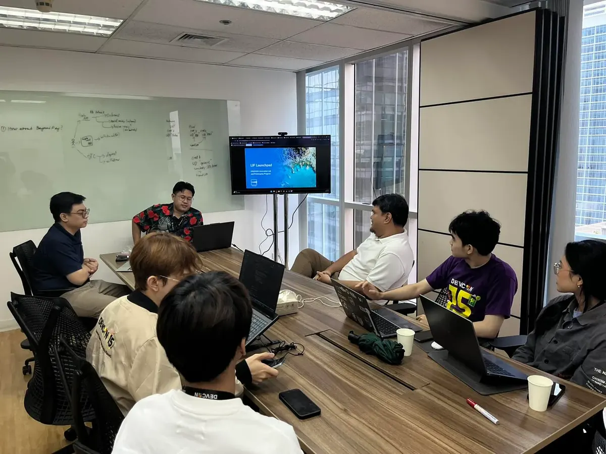 Interns and mentors in a boardroom session on an innovation and prototyping program